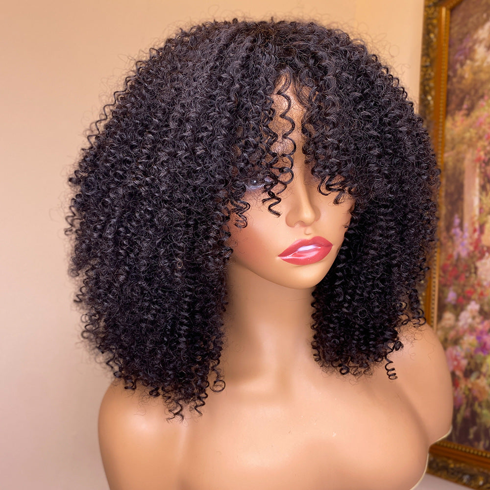Kinky curly human hair wig with bangs worn on a model, showing natural 4C curl blend and full fringe in 180 density