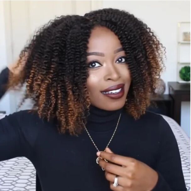Short curly ombre wig with long bangs showing full voluminous afro curl and black-to-brown gradient colour
